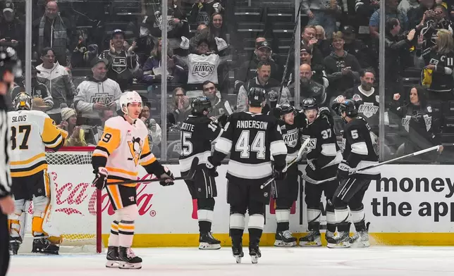 Los Angeles Kings players celebrate a goal by Warren Foegele (37) during the first period of an NHL hockey game against the Pittsburgh Penguins Thursday, Oct. 16, 2025, in Los Angeles. (AP Photo/Jae C. Hong)