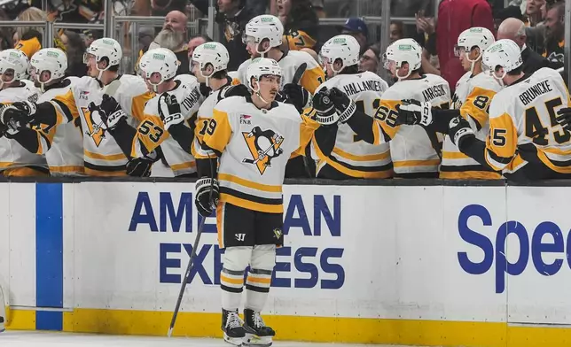 Pittsburgh Penguins center Connor Dewar (19) celebrates his goal with teammates during the second period of an NHL hockey game against the Los Angeles Kings Thursday, Oct. 16, 2025, in Los Angeles. (AP Photo/Jae C. Hong)