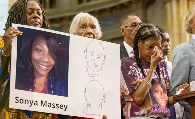 FILE - Donna Massey, center right, wipes tears from her face as she listens to Rev. Al Sharpton, right, speak during a press conference over the shooting death of her daughter Sonya, who was killed by Illinois sheriff's deputy Sean Grayson, at New Mount Pilgrim Church in the Garfield Park neighborhood in Chicago, Tuesday, July 30, 2024. (Tyler Pasciak LaRiviere/Chicago Sun-Times via AP, file)