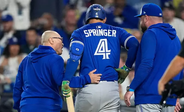 Toronto Blue Jays' George Springer leaves the game with an injury during the seventh inning in Game 3 of baseball's World Series against the Los Angeles Dodgers, Monday, Oct. 27, 2025, in Los Angeles. (AP Photo/Brynn Anderson)