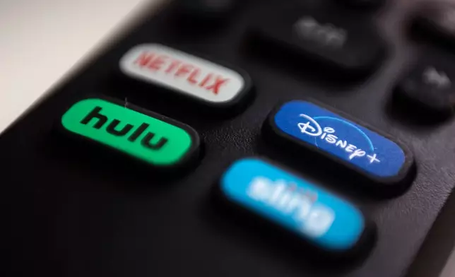 FILE - The logos for streaming services Netflix, Hulu, Disney Plus and Sling TV are pictured on a remote control on Aug. 13, 2020, in Portland, Ore. (AP Photo/Jenny Kane, File)