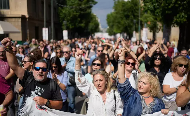 Protesters take part in a nationwide 24-hour strike in Athens, Greece, Wednesday, Oct. 1, 2025, as labor unions demand higher wages and the withdrawal of a bill changing work hours. (AP Photo/Petros Giannakouris)