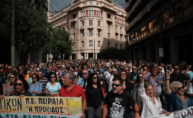 Protesters take part in a nationwide 24-hour strike in Athens, Greece, Wednesday, Oct. 1, 2025, as labor unions demand higher wages and the withdrawal of a bill changing work hours. (AP Photo/Thanassis Stavrakis)