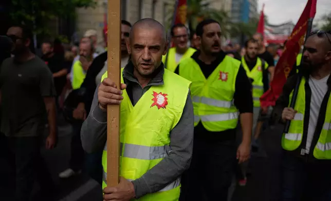 Protesters take part in a nationwide 24-hour strike in Athens, Greece, Wednesday, Oct. 1, 2025, as labor unions demand higher wages and the withdrawal of a bill changing work hours. (AP Photo/Thanassis Stavrakis)