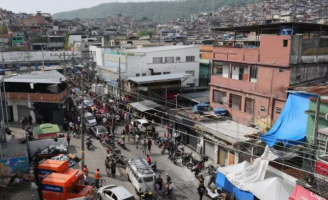 Residents surround the bodies of people killed the day before during a police raid targeting the Comando Vermelho gang in the Complexo da Penha favela of Rio de Janeiro, Brazil, Wednesday, Oct. 29, 2025. (AP Photo/Silvia Izquierdo)
