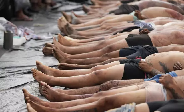 The bodies of people killed the day before during a police raid targeting the Comando Vermelho gang lie in the Complexo da Penha favela of Rio de Janeiro, Brazil, Wednesday, Oct. 29, 2025. (AP Photo/Silvia Izquierdo)