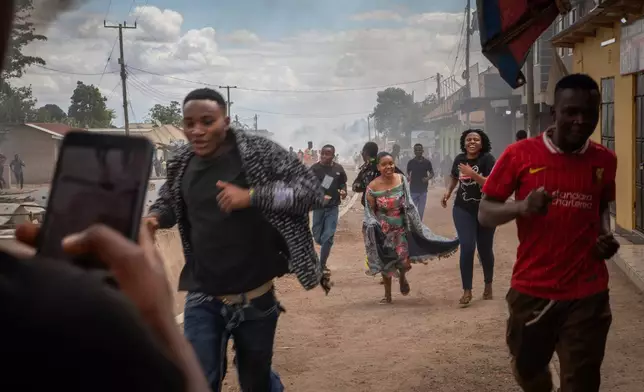 People run during a protest on the streets of Arusha, Tanzania, on election day Wednesday, Oct. 29, 2025. (AP Photo/str)