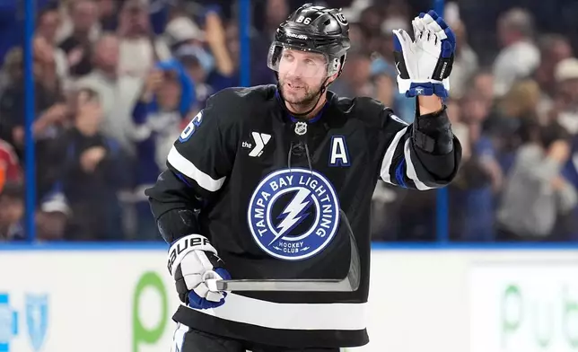 Tampa Bay Lightning right wing Nikita Kucherov (86) waves to the fans after picking up an assist, for his 1,000th career point, on a goal by Brayden Point during the second period of an NHL hockey game against the Anaheim Ducks Saturday, Oct. 25, 2025, in Tampa, Fla. (AP Photo/Chris O'Meara)