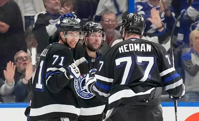 Tampa Bay Lightning center Anthony Cirelli (71) celebrates his goal against the Anaheim Ducks with defenseman Victor Hedman (77) and right wing Nikita Kucherov during the third period of an NHL hockey game Saturday, Oct. 25, 2025, in Tampa, Fla. (AP Photo/Chris O'Meara)