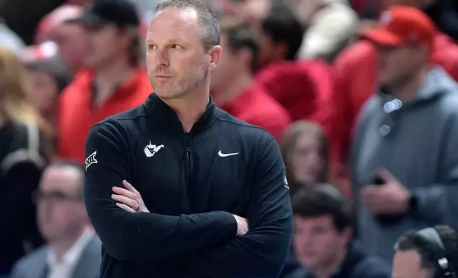 FILE - West Virginia head coach Darian DeVries looks on the court during the first half of an NCAA college basketball game against Texas Tech, Feb. 22, 2025, in Lubbock, Texas. (AP Photo/Annie Rice, File)
