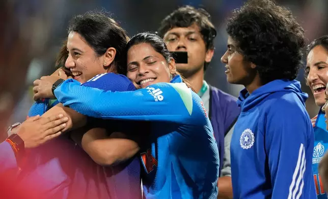 India's players celebrate after winning the ICC Women's Cricket World Cup cricket semi final against Australia in Navi Mumbai, India, Thursday, Oct. 30, 2025. (AP Photo/Rajanish Kakade)