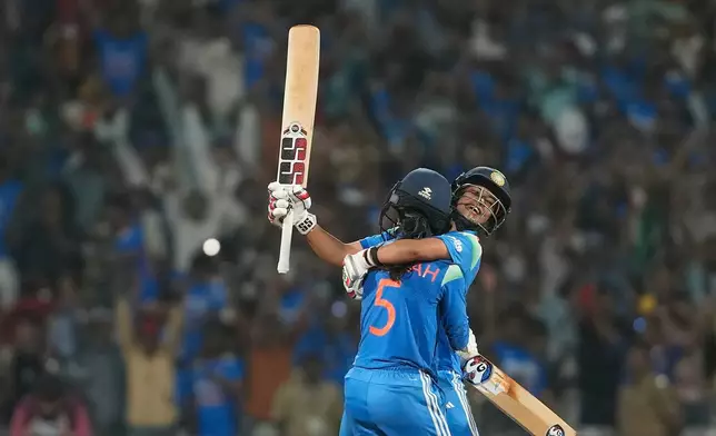 India's Jemimah Rodrigues, left, and India's Amanjot Kaur celebrates after winning the ICC Women's Cricket World Cup cricket semi final against Australia in Navi Mumbai, India, Thursday, Oct. 30, 2025. (AP Photo/Rajanish Kakade)