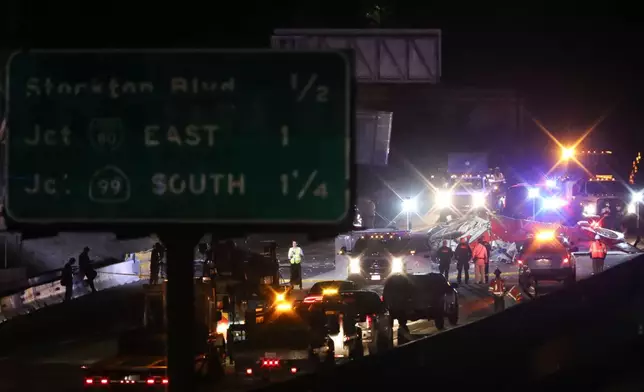 A medical helicopter is shown after it crashed on Highway 50 Monday, Oct. 6, 2025, in Sacramento, Calif. (AP Photo/Scott Marshall)