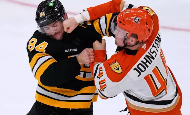Anaheim Ducks left wing Ross Johnston (44) lands a punch in a fight against Boston Bruins left wing Tanner Jeannot (84) during the second period of an NHL hockey game, Thursday, Oct. 23, 2025, in Boston. (AP Photo/Charles Krupa)