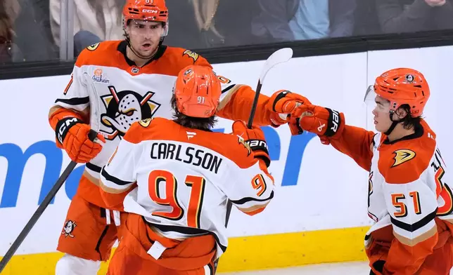 Anaheim Ducks left wing Cutter Gauthier, left, is congratulated after his goal against the Boston Bruins during the second period of an NHL hockey game, Thursday, Oct. 23, 2025, in Boston. (AP Photo/Charles Krupa)