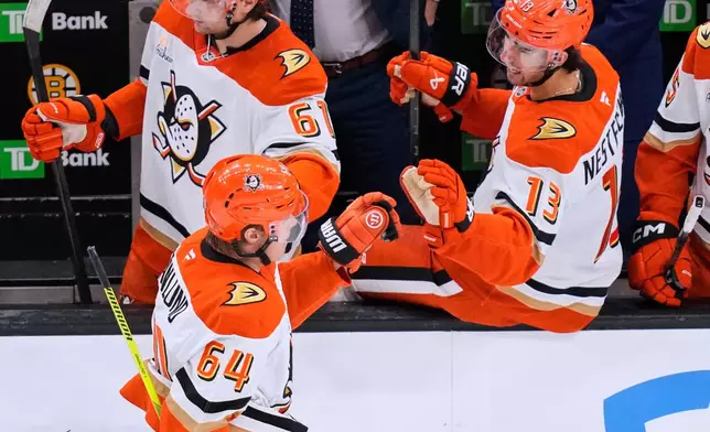 Anaheim Ducks center Mikael Granlund (64) is congratulated after his goal against the Boston Bruins during the third period of an NHL hockey game, Thursday, Oct. 23, 2025, in Boston. (AP Photo/Charles Krupa)
