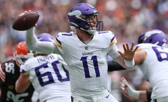Minnesota Vikings quarterback Carson Wentz (11) passes the ball during the first half of the NFL game between Minnesota Vikings and Cleveland Browns at the Tottenham Hotspur stadium in London, Sunday, Oct. 5, 2025. (AP Photo/Ian Walton)
