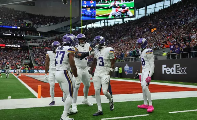 Minnesota Vikings wide receiver Jordan Addison (3) celebrates with his teammates after scoring a touchdown during the second half of the NFL game between Minnesota Vikings and Cleveland Browns at the Tottenham Hotspur stadium in London, Sunday, Oct. 5, 2025. (AP Photo/Ian Walton)