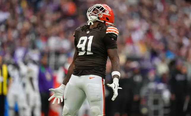 Cleveland Browns defensive end Alex Wright (91) reacts after sacking Minnesota Vikings quarterback Carson Wentz (11) during the second half of the NFL game between Minnesota Vikings and Cleveland Browns at the Tottenham Hotspur stadium in London, Sunday, Oct. 5, 2025. (AP Photo/Kirsty Wigglesworth)