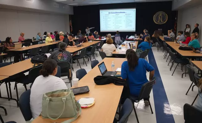 Kathleen Torregrossa, Ed.D, rear, lectures during a Microsoft AI skilling event, Saturday, Sept. 27, 2025, in San Antonio. (AP Photo/Darren Abate)