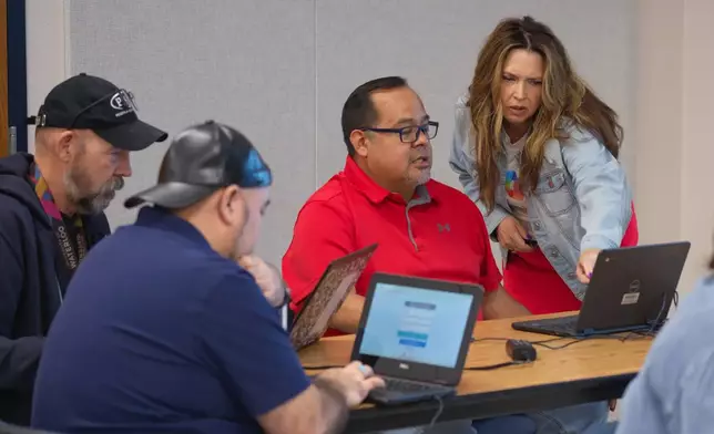 Dr. Geri Gillespy, Microsoft industry advisor, right, speaks with attendees during a Microsoft AI skilling event, Saturday, Sept. 27, 2025, in San Antonio. (AP Photo/Darren Abate)