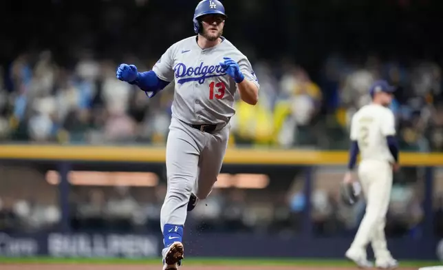 Los Angeles Dodgers' Max Muncy celebrates after a home run against the Milwaukee Brewers during the sixth inning in Game 2 of baseball's National League Championship Series, Tuesday, Oct. 14, 2025, in Milwaukee. (AP Photo/Ashley Landis)