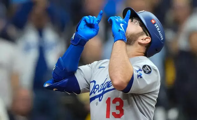 Los Angeles Dodgers' Max Muncy celebrates after a home run against the Milwaukee Brewers during the sixth inning in Game 2 of baseball's National League Championship Series, Tuesday, Oct. 14, 2025, in Milwaukee. (AP Photo/Brynn Anderson)