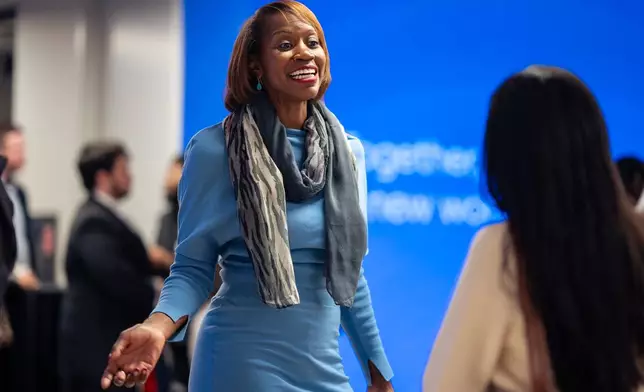 Kendra Parlock, Vice President of Partnership Development at NPower, talks to an NPower alumna during an event at World Wide Technology, Monday, Oct. 20, 2025, in New York. (AP Photo/Angelina Katsanis)