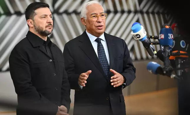 Ukraine's President Volodymyr Zelenskyy, left, and European Council President Antonio Costa speak with the media as they arrive for an EU Summit at the European Council building in Brussels, Thursday, Oct. 23, 2025. (AP Photo/Harry Nakos)