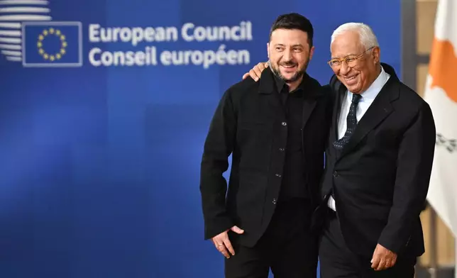 Ukraine's President Volodymyr Zelenskyy, left, and European Council President Antonio Costa arrive for an EU Summit at the European Council building in Brussels, Thursday, Oct. 23, 2025. (AP Photo/Harry Nakos)