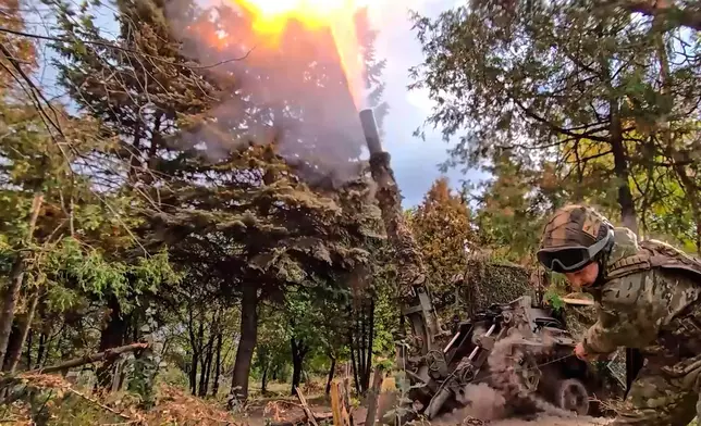 In this photo taken from video distributed by Russian Defense Ministry Press Service on Thursday, Oct. 23, 2025, the Russian 240mm "Tyulpan" mortar fires towards Ukrainian positions on an undisclosed location in Ukraine. (Russian Defense Ministry Press Service via AP)