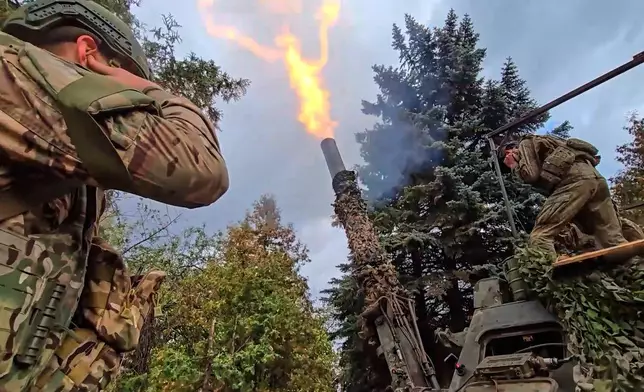 In this photo taken from video distributed by Russian Defense Ministry Press Service on Thursday, Oct. 23, 2025, the Russian 240mm "Tyulpan" mortar fires towards Ukrainian positions on an undisclosed location in Ukraine. (Russian Defense Ministry Press Service via AP)