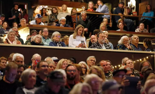 A crowd watches as Democratic Maine Senate candidate Graham Platner speaks at a town hall in Ogunquit, Maine, Wednesday, Oct. 22, 2025. (AP Photo/Caleb Jones)
