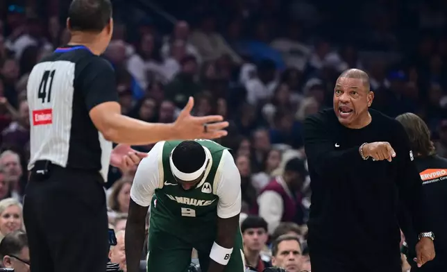 Milwaukee Bucks head coach Doc Rivers, right, disputes a call with referee Nate Green, left, in the first half of an NBA basketball game against the Cleveland Cavaliers, Sunday, Oct. 26, 2025, in Cleveland. (AP Photo/David Dermer)