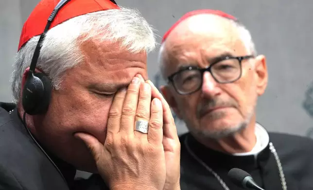 Cardinals Konrad Krajewski, left, and Michael Czerny attend a press conference at the Vatican to present Pope Leo XIV's exhortation "Dilexi te"about love for the poor, Thursday, Oct. 9, 2025. (AP Photo/Domenico Stinellis)