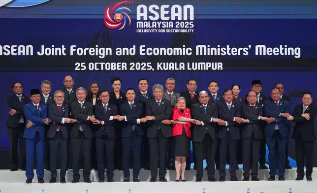 Foreign ministers and economic ministers of ASEAN member countries pose for a group photo during the ASEAN Joint Foreign and Economic Ministers' Meeting in Kuala Lumpur, Malaysia, on Saturday, Oct. 25, 2025. (AP Photo/Rafiq Maqbool)