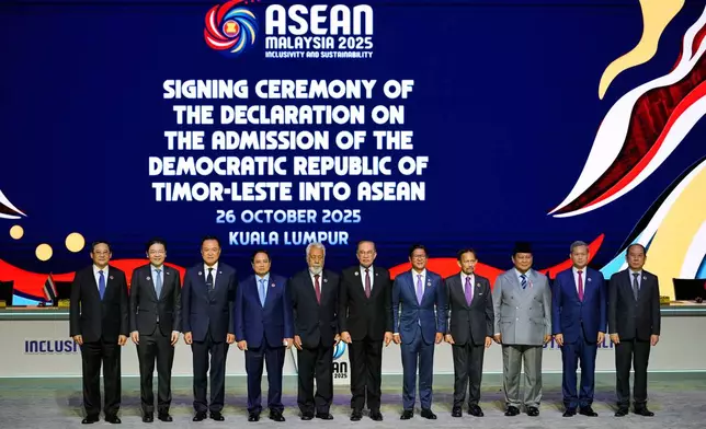 From left, Laos' Prime Minister Sonexay Siphandone, Singapore's Prime Minister Lawrence Wong, Thailand's Prime Minister Anutin Charnvirakul, Vietnam's Prime Minister Pham Minh Chinh, East Timor's Prime Minister Kay Rala Xanana Gusmao, Malaysia's Prime Minister Anwar Ibrahim, Philippines' President Ferdinand Marcos Jr., Brunei's King Sultan Hassanal Bolkiah, Indonesian President Prabowo Subianto, Cambodian Prime Minister Hun Manet and Myanmar's Permanent Secretary of the Ministry of Foreign Affairs U Hau Khan Sum pose for a photo during the signing ceremony of the Declaration on the Admission of East Timor into ASEAN during the 47th ASEAN summit, in Kuala Lumpur, Malaysia, Sunday, Oct. 26, 2025. (AP Photo/Vincent Thian)