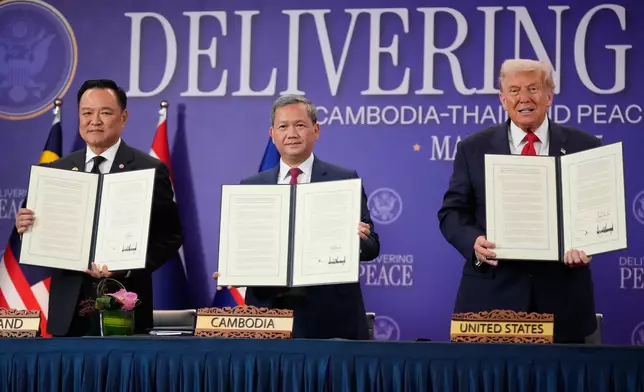 President Donald Trump, Cambodian Prime Minister Hun Manet, left, and Thailand's Prime Minister Anutin Charnvirakul pose with their documents during a signing ceremony on the sidelines of the ASEAN Summit in Kuala Lumpur, Malaysia, Sunday, Oct. 26, 2025. (AP Photo/Mark Schiefelbein)