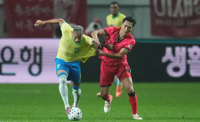 Brazil's Richarlison, left, and South Korea's Won Du-jae fight for the ball during the international friendly soccer match between South Korea and Brazil at Seoul World Cup Stadium in Seoul, South Korea, Friday, Oct. 10, 2025. (AP Photo/Lee Jin-man)