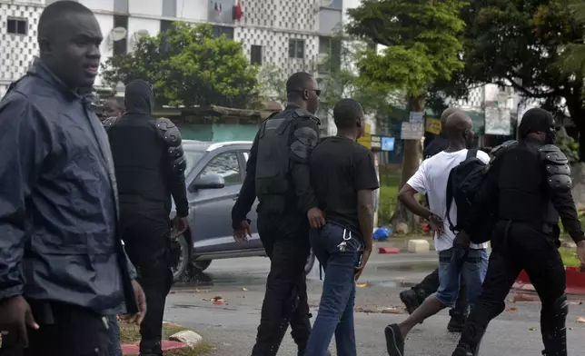 Police arrest a protester during clashes with opposition supporters in Abidjan, Ivory Coast, Saturday, Oct. 11, 2025 (AP Photo/Diomande Ble Blonde)