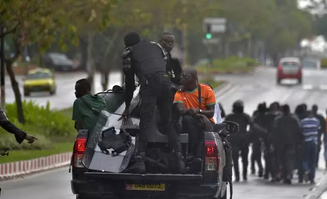 Police arrest a protester during clashes with opposition supporters in Abidjan, Ivory Coast, Saturday, Oct. 11, 2025 (AP Photo/Diomande Ble Blonde)