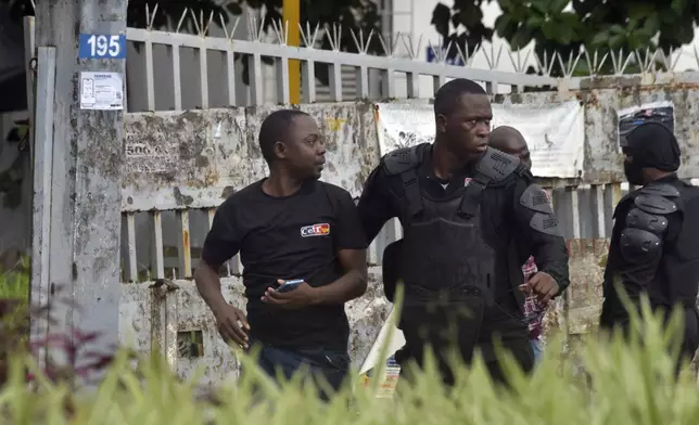 Police arrest a protester during clashes with opposition supporters in Abidjan, Ivory Coast, Saturday, Oct. 11, 2025 (AP Photo/Diomande Ble Blonde)