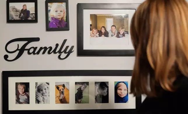 Meaghan Marr looks at photographs of her family's former pets on Thursday, Sept. 25, 2025, in Cartersville, Ga. (AP Photo/Brynn Anderson)