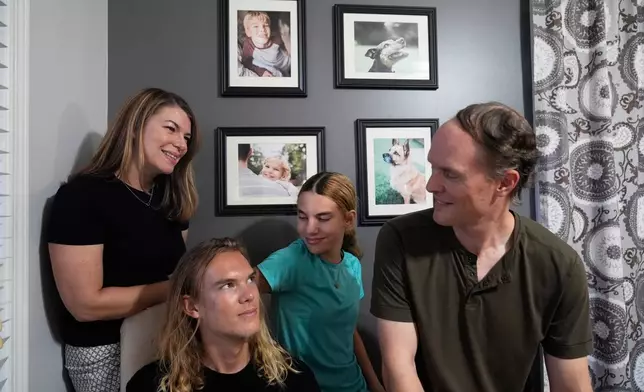 Meaghan and Chris Marr prepare to pose for a photograph with their children on Thursday, Sept. 25, 2025, in Cartersville, Ga. (AP Photo/Brynn Anderson)