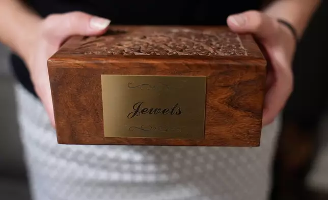 Meaghan Marr holds the ashes her previous dog, Jewels, on Thursday, Sept. 25, 2025, in Cartersville, Ga. (AP Photo/Brynn Anderson)