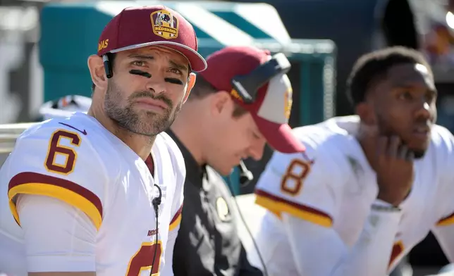 FILE - Washington Redskins quarterback Mark Sanchez (6) watches from the bench with passing game coordinator Kevin O'Connell, center, and quarterback Josh Johnson (8) during the first half of an NFL football game against the Jacksonville Jaguars Sunday, Dec. 16, 2018, in Jacksonville, Fla. (AP Photo/Phelan M. Ebenhack, File)