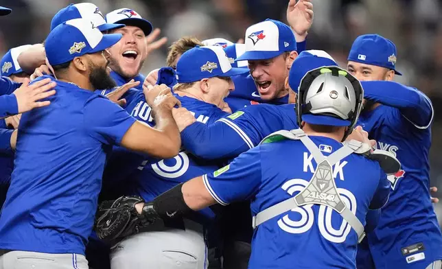 The Toronto Blue Jays celebrate after defeating the New York Yankees in Game 4 of baseball's American League Division Series, Wednesday, Oct. 8, 2025, in New York. (AP Photo/Frank Franklin II)