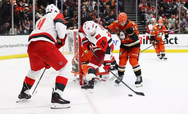 Carolina Hurricanes left wing William Carrier (28) attempts to score against Anaheim Ducks goaltender Lukas Dostal (1) during the second period of an NHL hockey game Thursday, Oct. 16, 2025, in Anaheim, Calif. (AP Photo/Ethan Swope)