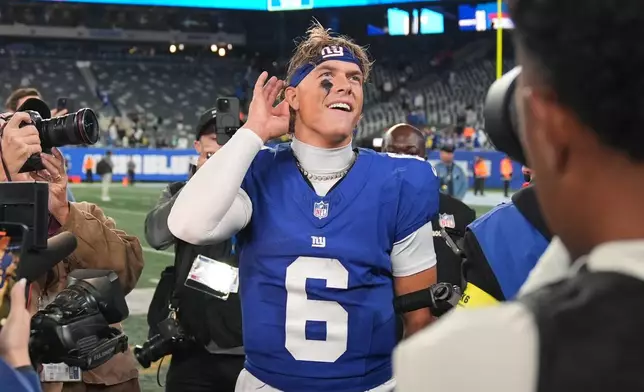New York Giants' Jaxson Dart reacts after an NFL football game against the Philadelphia Eagles Thursday, Oct. 9, 2025, in East Rutherford, N.J. (AP Photo/Seth Wenig)