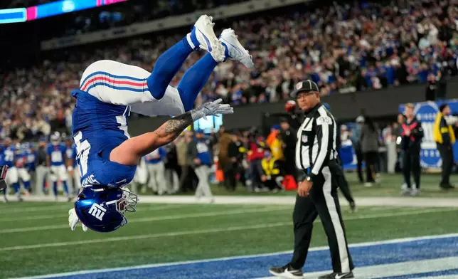 New York Giants' Cam Skattebo reacts after a touchdown during the second half of an NFL football game against the Philadelphia Eagles Thursday, Oct. 9, 2025, in East Rutherford, N.J. (AP Photo/Seth Wenig)